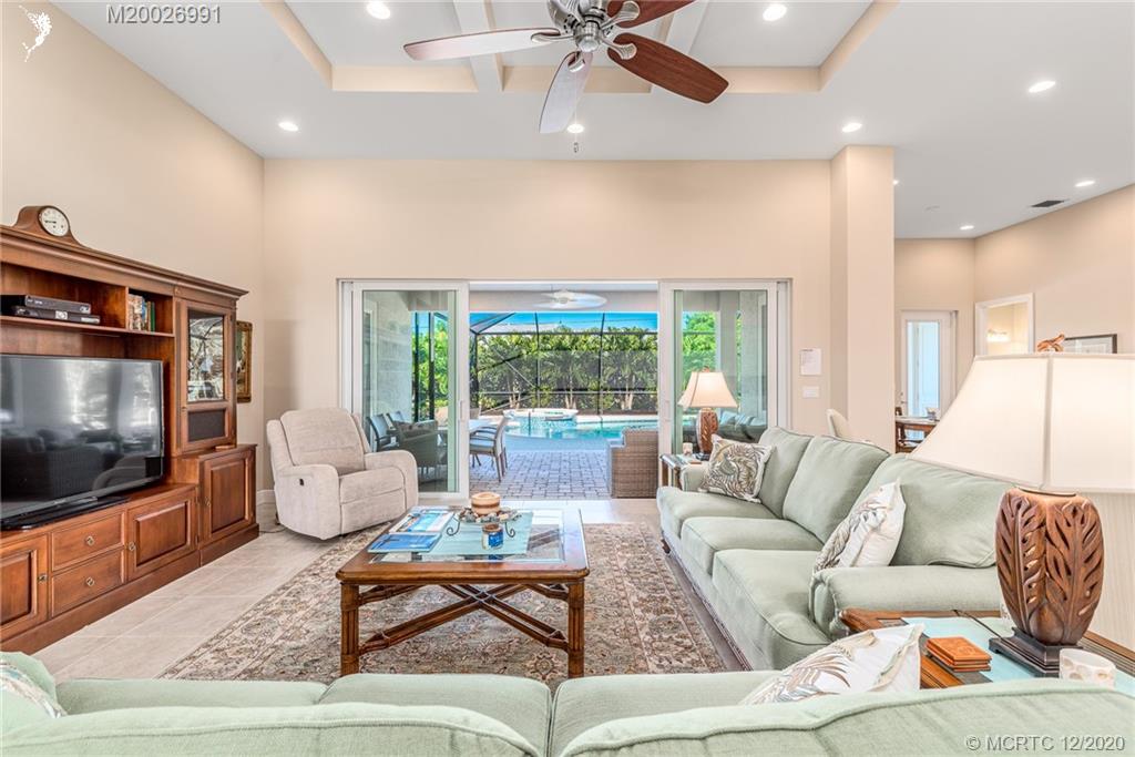 4981 Southeast Inlet Isle Way Stuart, FL 34997 - Photo 17 of 42 a living room with furniture and a flat screen tv