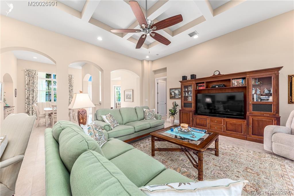4981 Southeast Inlet Isle Way Stuart, FL 34997 - Photo 18 of 42 a living room with furniture and a flat screen tv