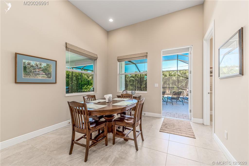 4981 Southeast Inlet Isle Way Stuart, FL 34997 - Photo 26 of 42 a view of a dining room with furniture and a potted plant