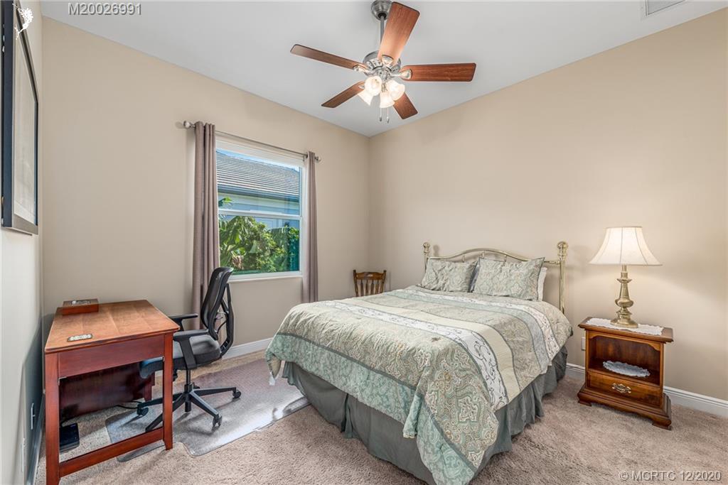 4981 Southeast Inlet Isle Way Stuart, FL 34997 - Photo 34 of 42 a bedroom with a bed and a window