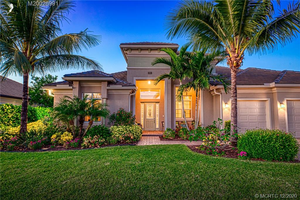 4981 Southeast Inlet Isle Way Stuart, FL 34997 - Photo 39 of 42 a view of a house with a yard and palm trees