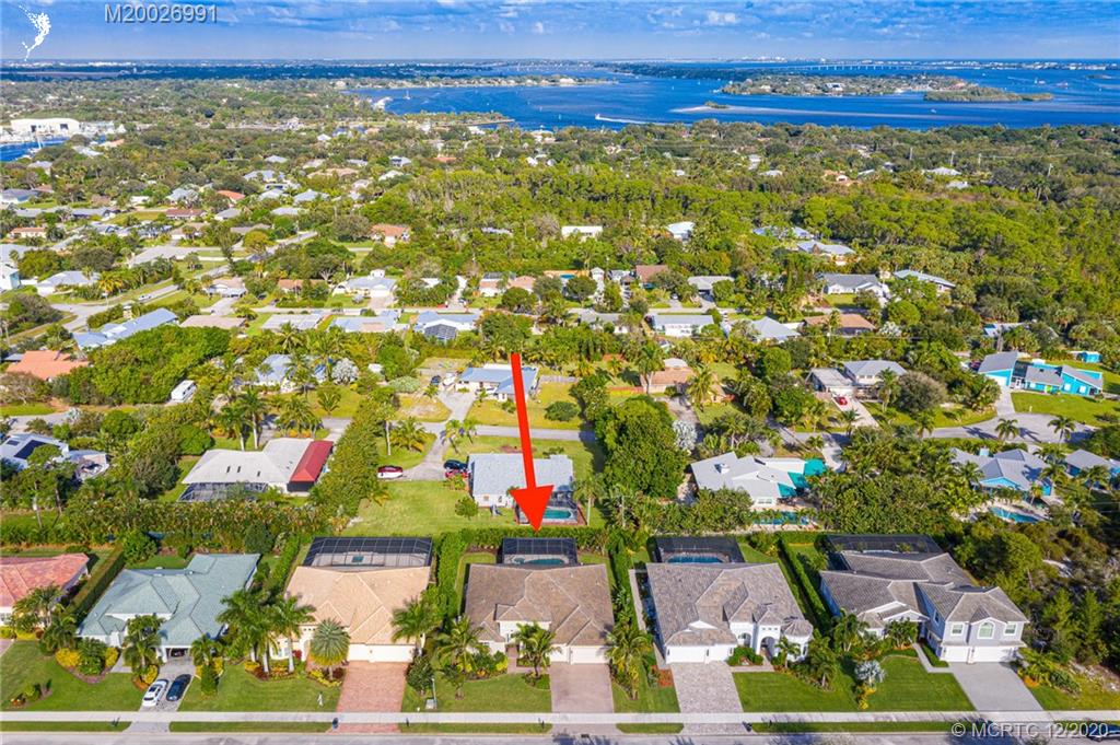 4981 Southeast Inlet Isle Way Stuart, FL 34997 - Photo 41 of 42 an aerial view of residential houses with outdoor space and trees