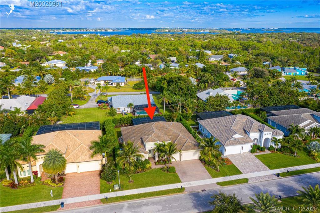 4981 Southeast Inlet Isle Way Stuart, FL 34997 - Photo 42 of 42 an aerial view of residential houses with outdoor space and swimming pool