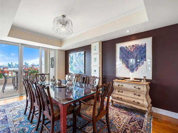 a living room with furniture kitchen view and large windows