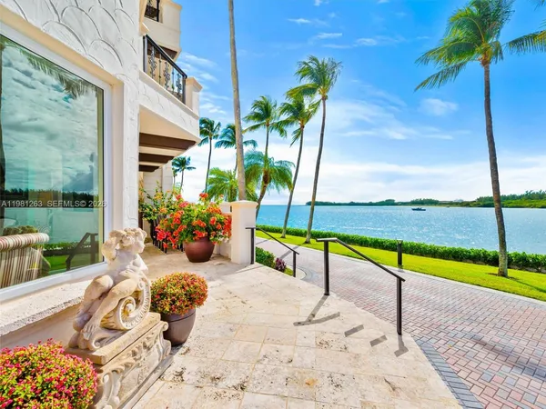 a kitchen with stainless steel appliances granite countertop a stove top oven a sink a dining table and chairs with wooden floor