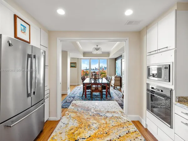 a kitchen with refrigerator and cabinets