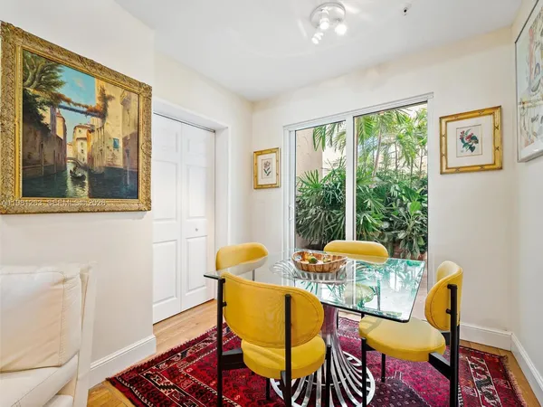 a bed room with a bed television and a window