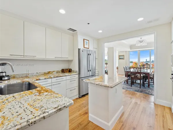 a living room with furniture and floor to ceiling windows