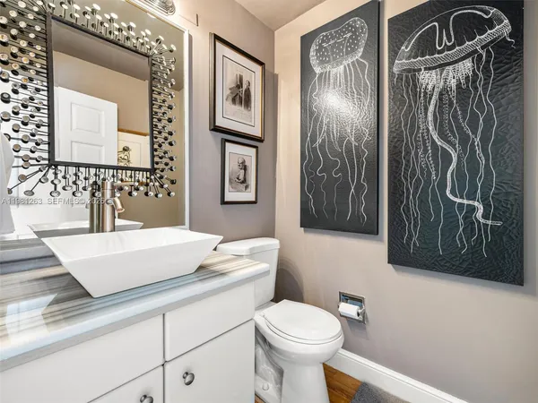 a view of a patio with table and chairs potted plants and large trees