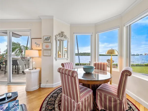 a living room with furniture fireplace and a large window