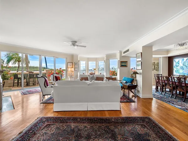 a dining room with furniture and potted plants