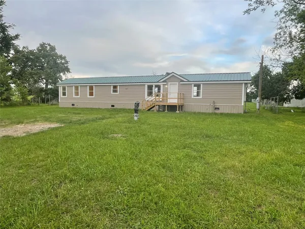 a front of a house with a garden and yard