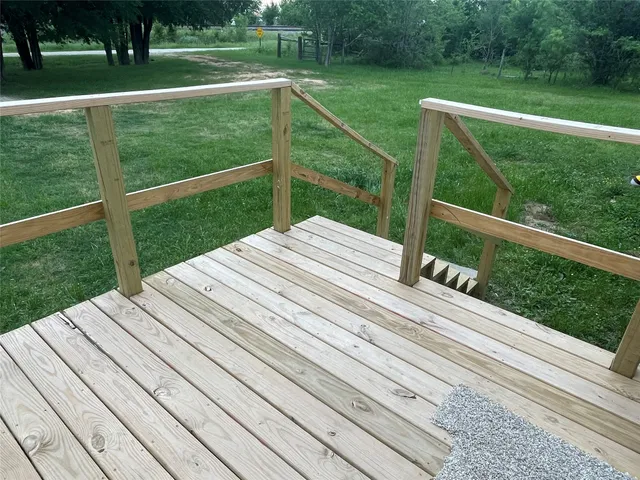 a view of a balcony with yard