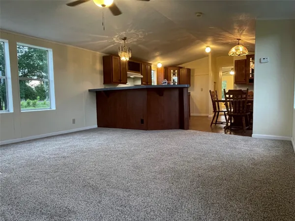 a view of a kitchen and a refrigerator