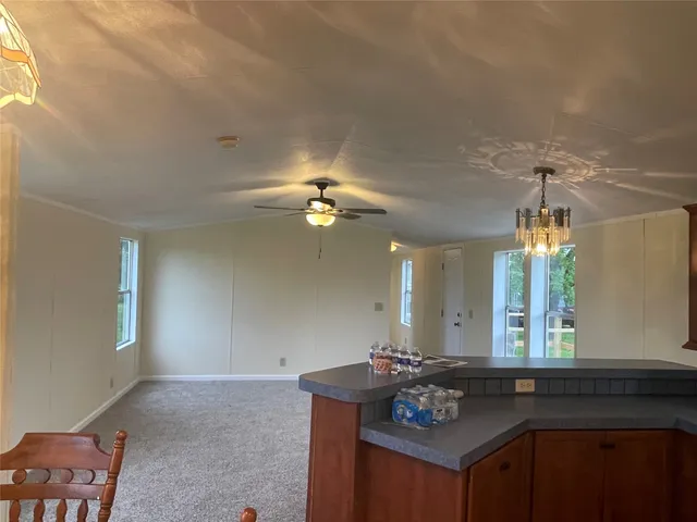 a living room with granite countertop furniture a chandelier and a window