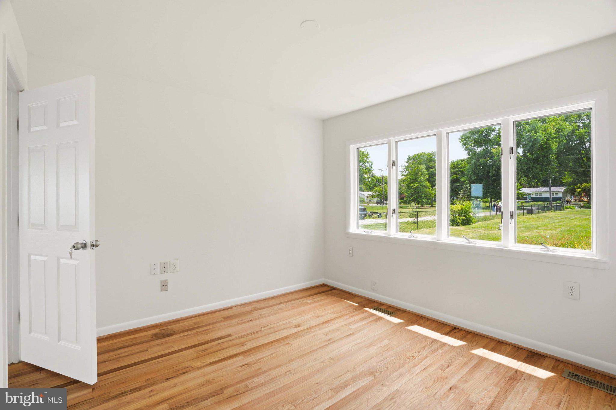 1100 River Bay Road Annapolis, MD 21409 - Photo 38 of 67 a view of an empty room with wooden floor and a window