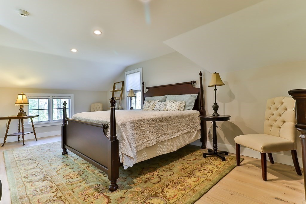36 Captain Baker Road Marstons Mills, MA 02648 - Photo 17 of 36 a bedroom with a bed a table and chair