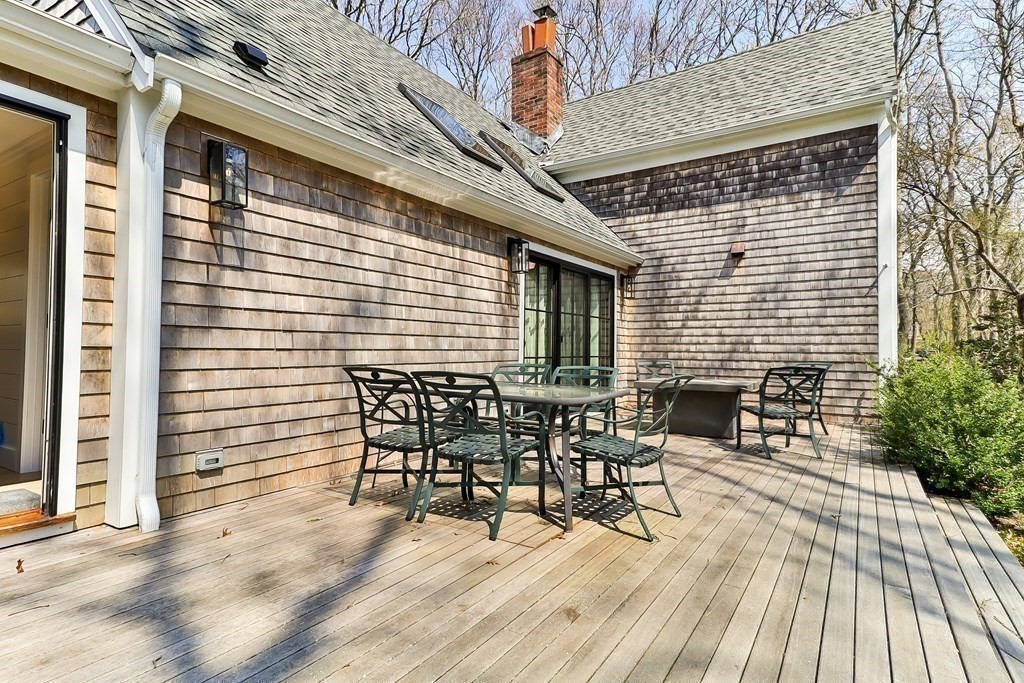 36 Captain Baker Road Marstons Mills, MA 02648 - Photo 35 of 36 a view of a patio with table and chairs and wooden floor