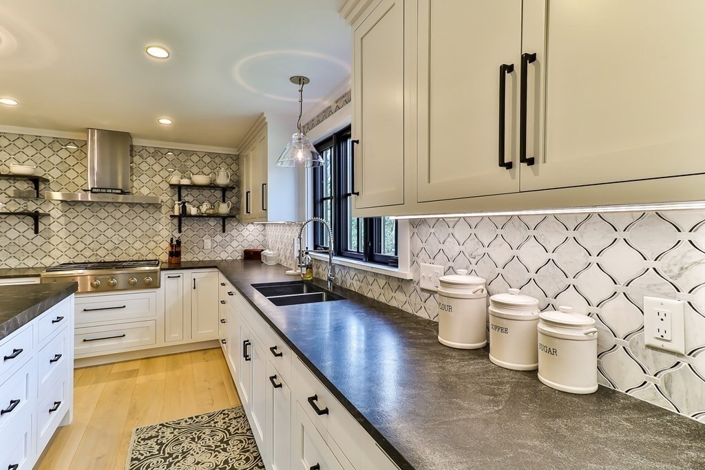 36 Captain Baker Road Marstons Mills, MA 02648 - Photo 4 of 36 a kitchen with a sink and wooden cabinets