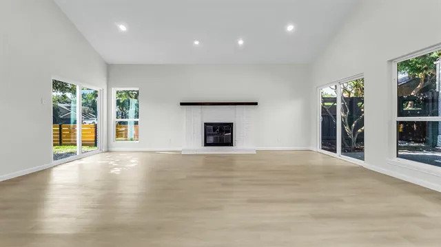a kitchen with kitchen island white cabinets and stainless steel appliances