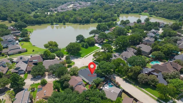 an aerial view of residential house with outdoor space and lake view