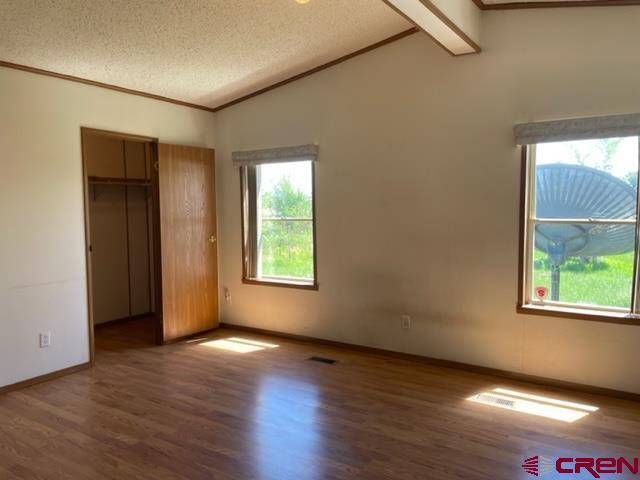 16022 B Road Delta, CO 81416 - Photo 11 of 35 an empty room with wooden floor and windows