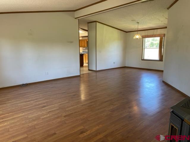 16022 B Road Delta, CO 81416 - Photo 5 of 35 an empty room with wooden floor and windows