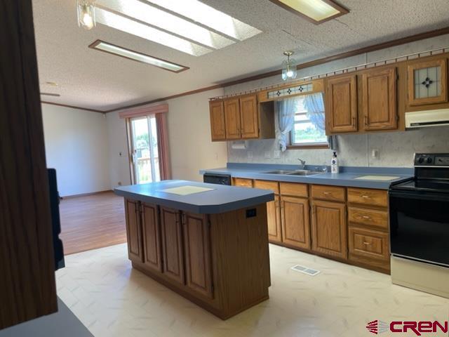 16022 B Road Delta, CO 81416 - Photo 8 of 35 a kitchen with kitchen island granite countertop a sink window and cabinets
