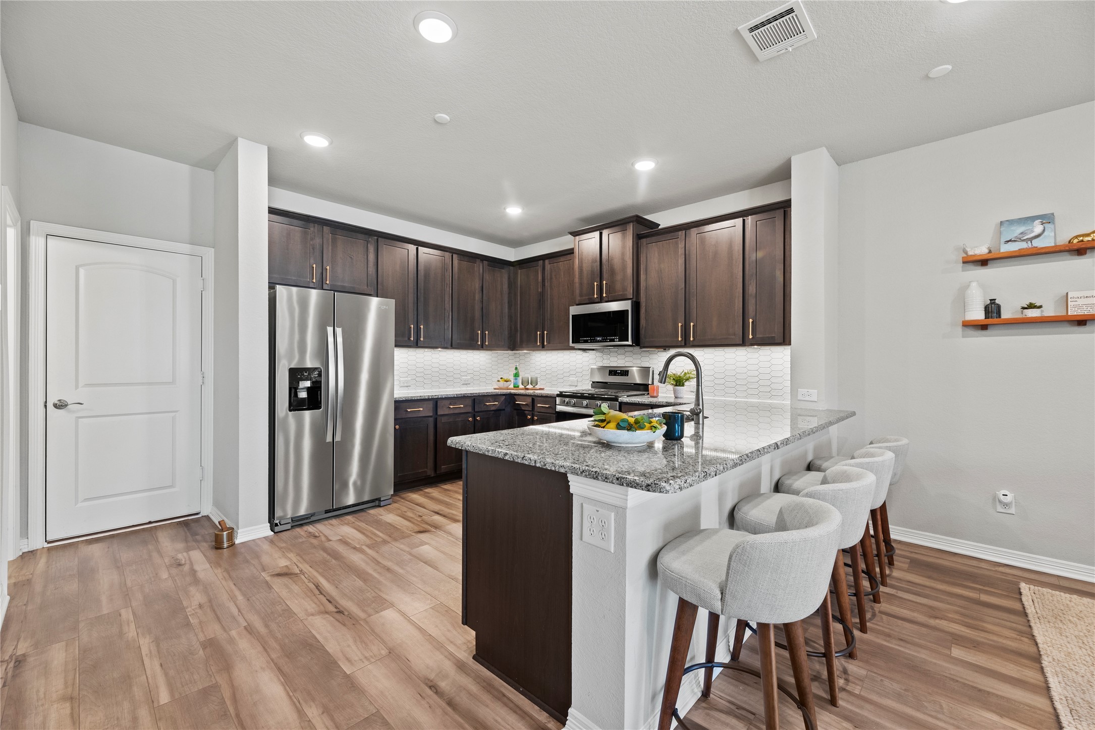 8001 Scanlan Trail Missouri City, TX 77459 - Photo 11 of 41 a kitchen with stainless steel appliances granite countertop a refrigerator and a stove top oven