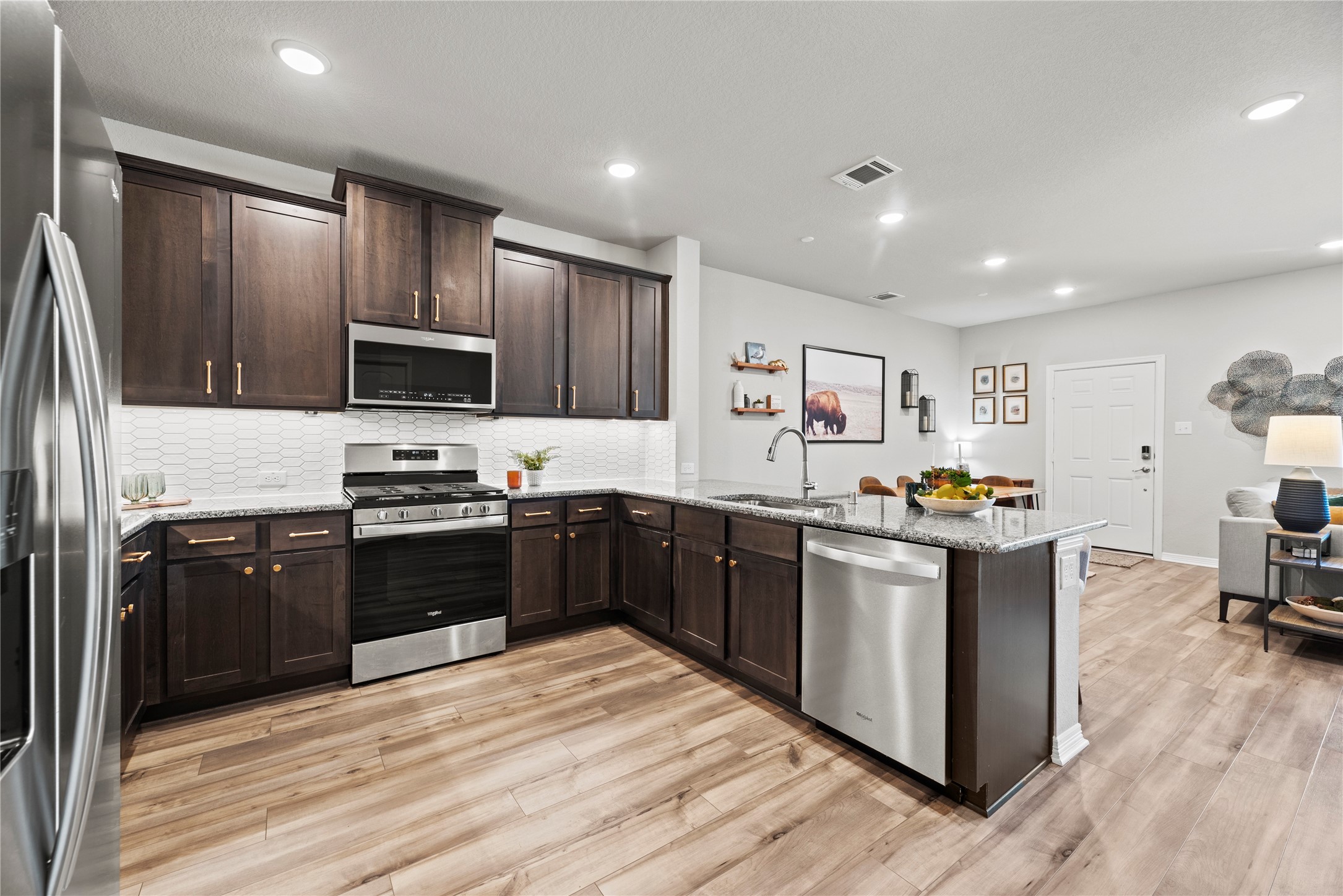 8001 Scanlan Trail Missouri City, TX 77459 - Photo 12 of 41 a kitchen with stainless steel appliances kitchen island granite countertop a refrigerator stove and sink