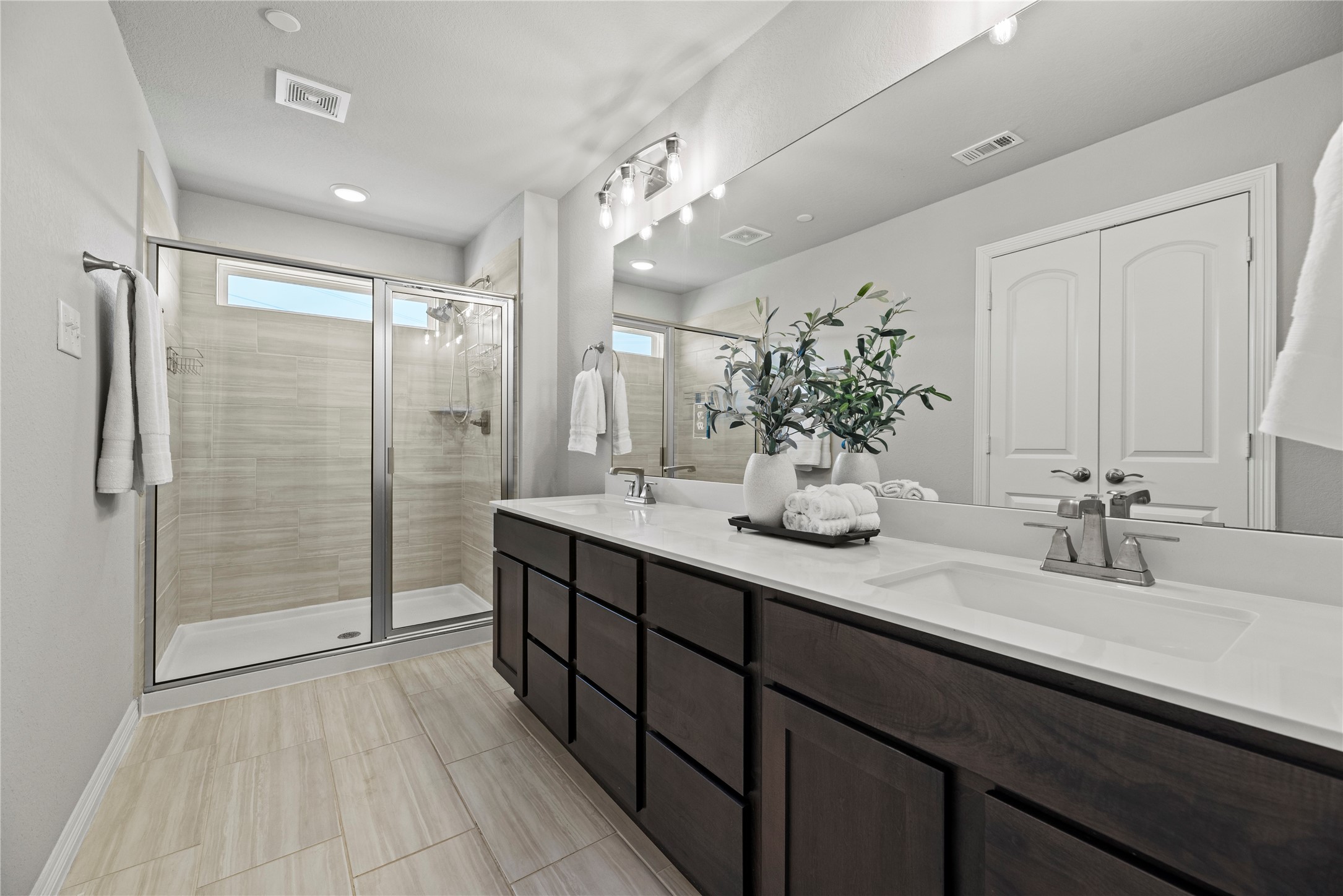 8001 Scanlan Trail Missouri City, TX 77459 - Photo 20 of 41 a bathroom with a double vanity sink mirror and shower