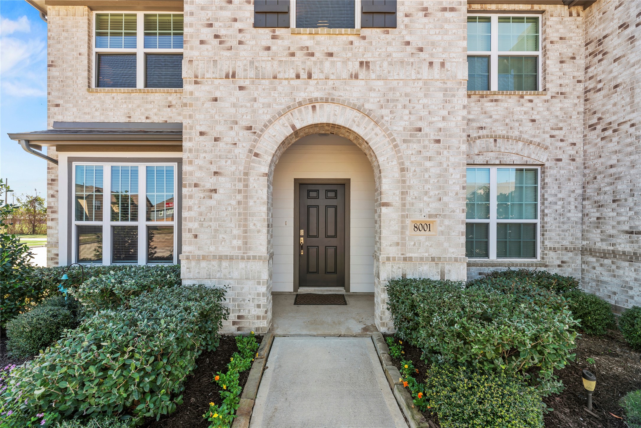 8001 Scanlan Trail Missouri City, TX 77459 - Photo 39 of 41 front view of a brick house with large windows