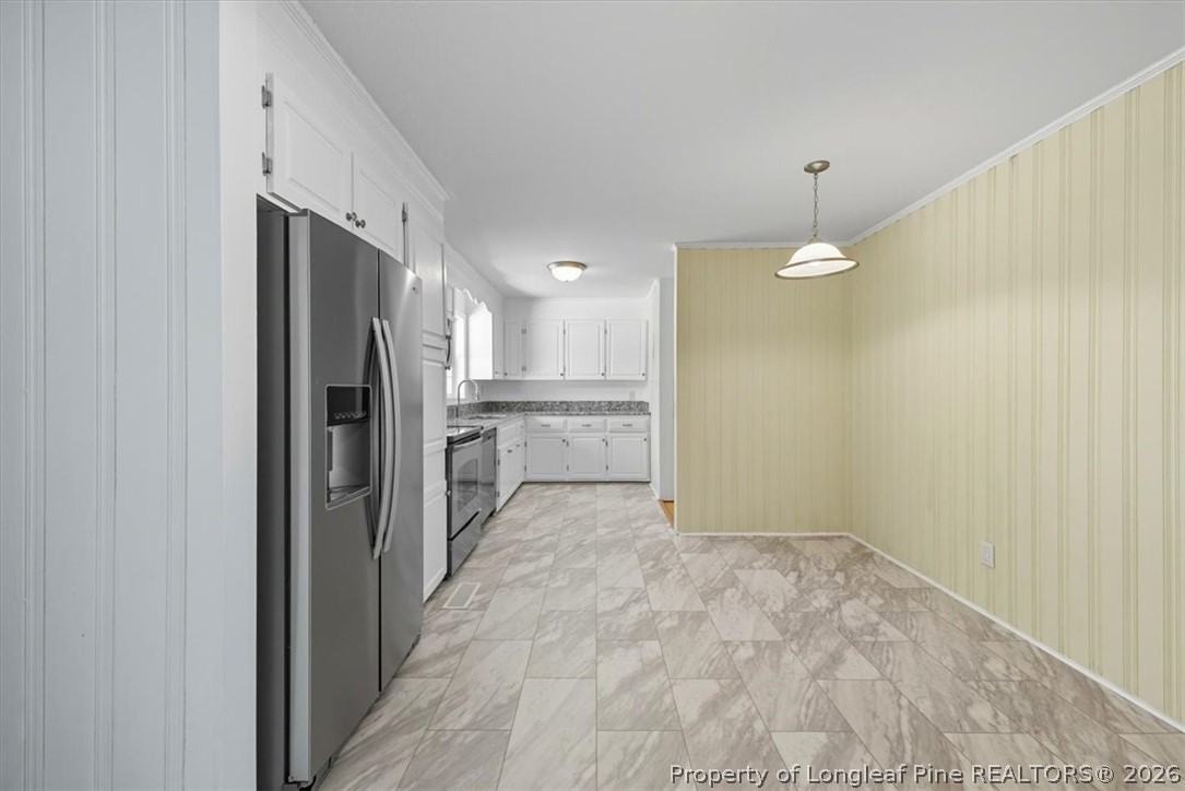 2604 Huntington Road Fayetteville, NC 28303 - Photo 12 of 46 a view of a kitchen with a sink and refrigerator