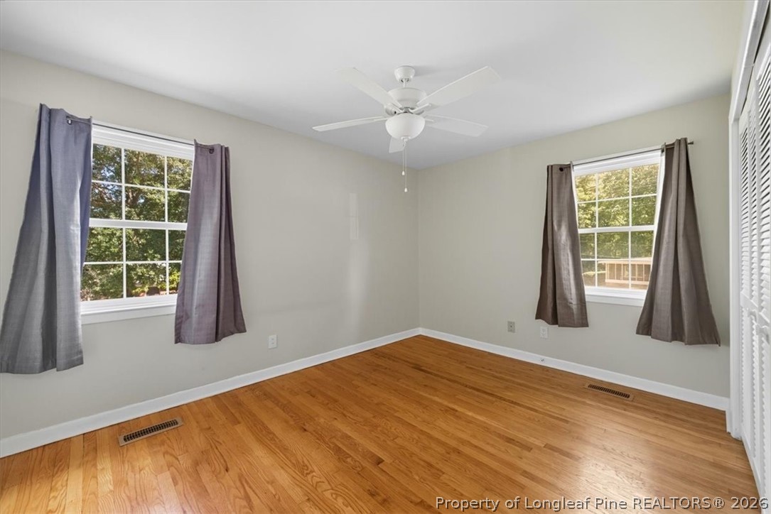 2604 Huntington Road Fayetteville, NC 28303 - Photo 23 of 46 a view of an empty room with wooden floor and a window