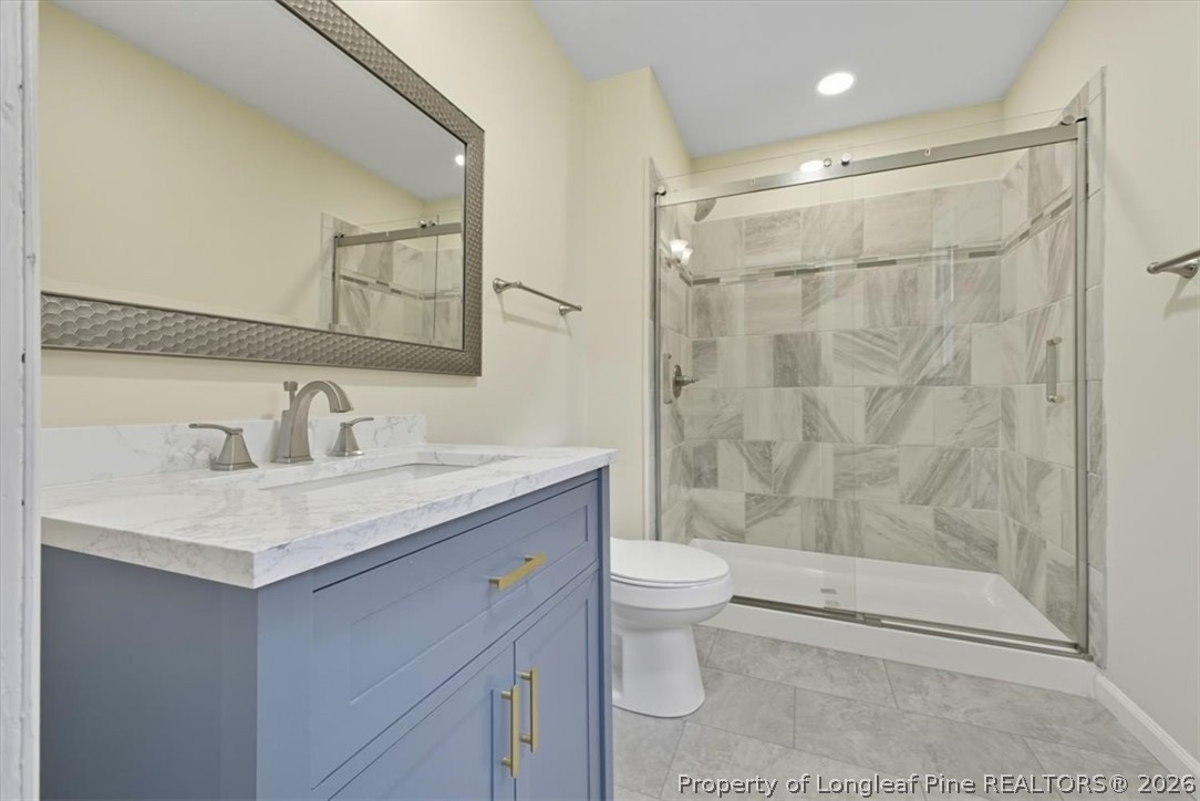 2604 Huntington Road Fayetteville, NC 28303 - Photo 25 of 46 a bathroom with a sink a toilet and shower