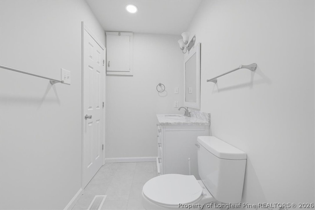 2604 Huntington Road Fayetteville, NC 28303 - Photo 33 of 46 a white toilet sitting next to a bathroom sink