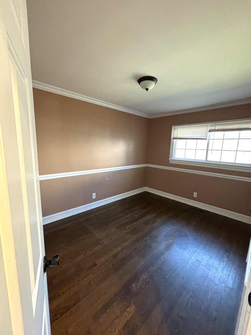115 Saugatuck Road Montgomery, IL 60538 - Photo 14 of 17 an empty room with wooden floor and windows