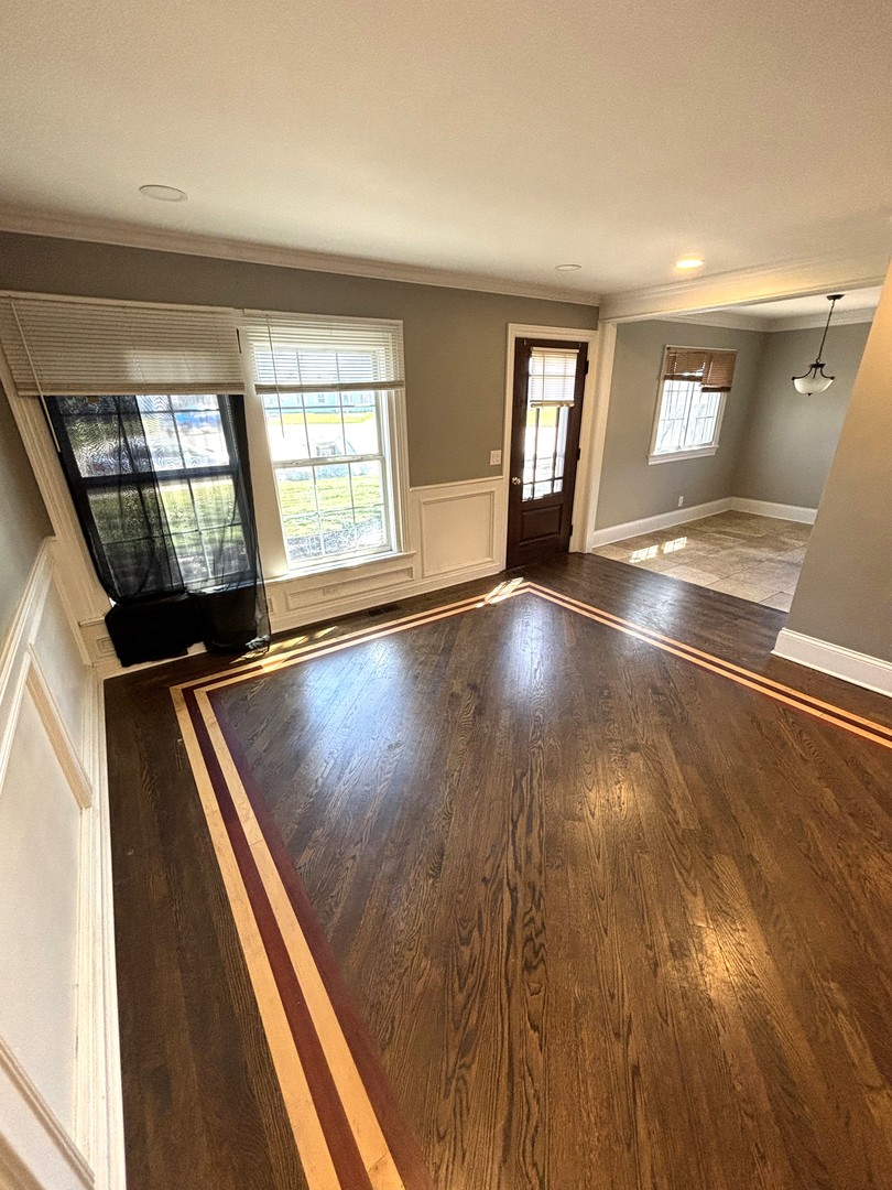 115 Saugatuck Road Montgomery, IL 60538 - Photo 2 of 17 an empty room with wooden floor and windows