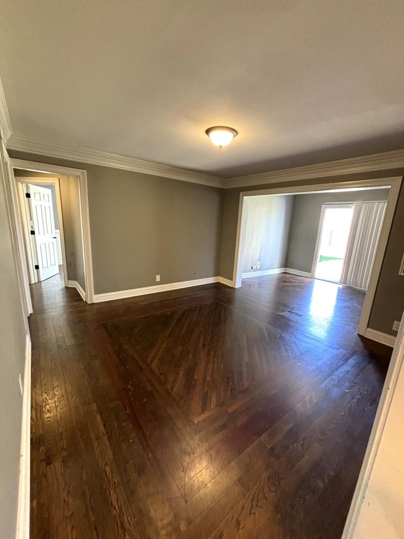 115 Saugatuck Road Montgomery, IL 60538 - Photo 8 of 17 wooden floor in an empty room with a window