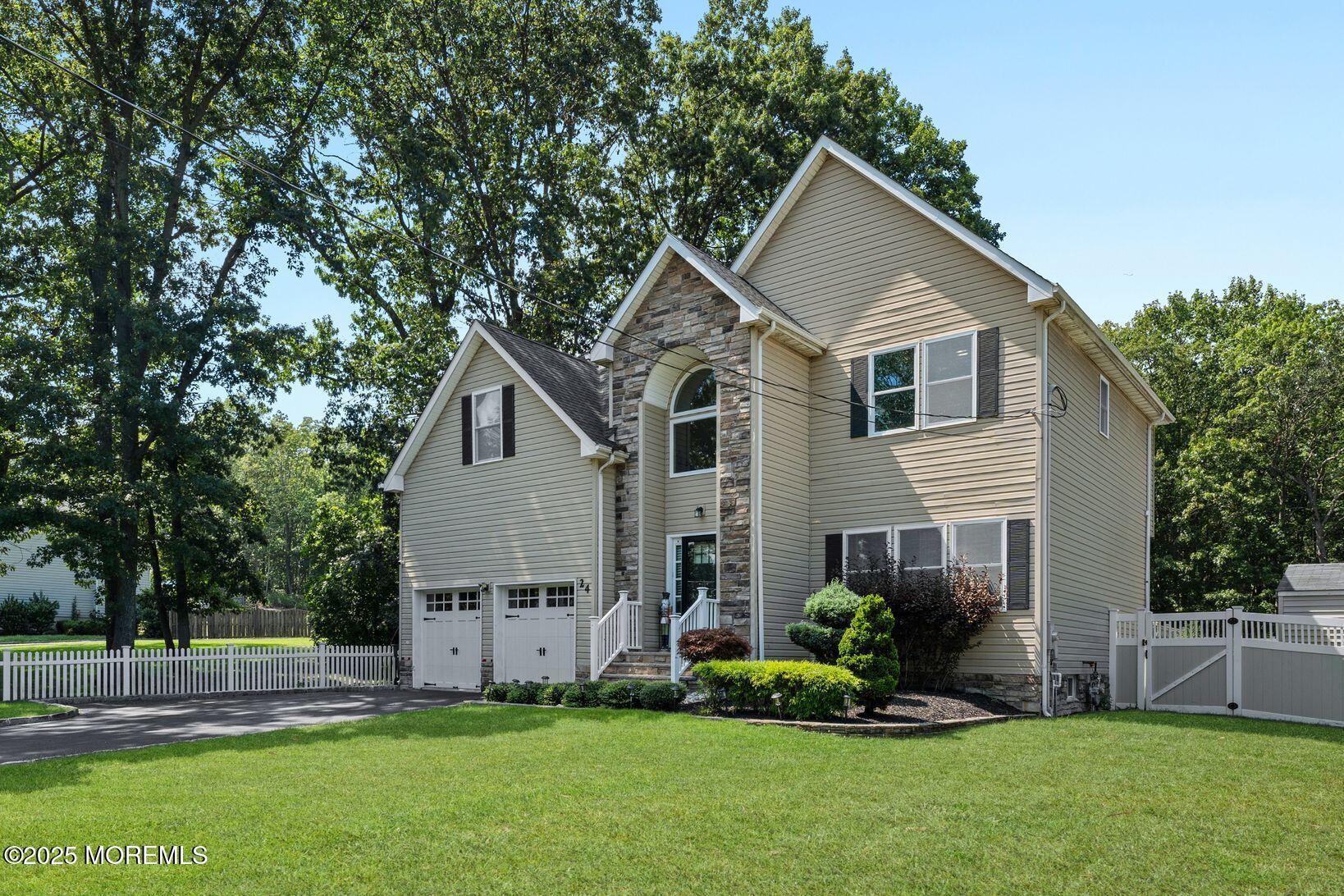 24 Friendship Road Howell, NJ 07731 - Photo 1 of 34 a front view of house with a garden