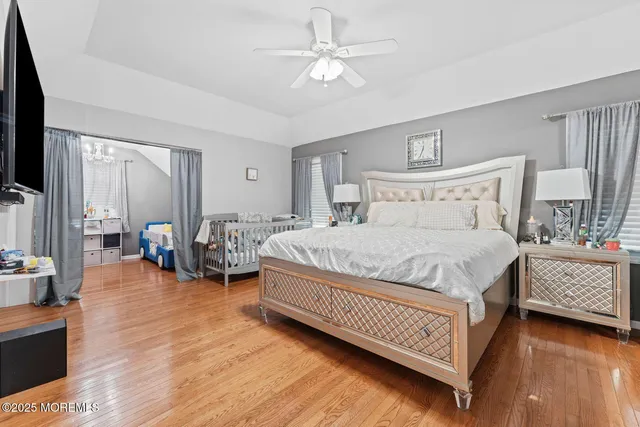 a spacious bedroom with a bed and a chandelier