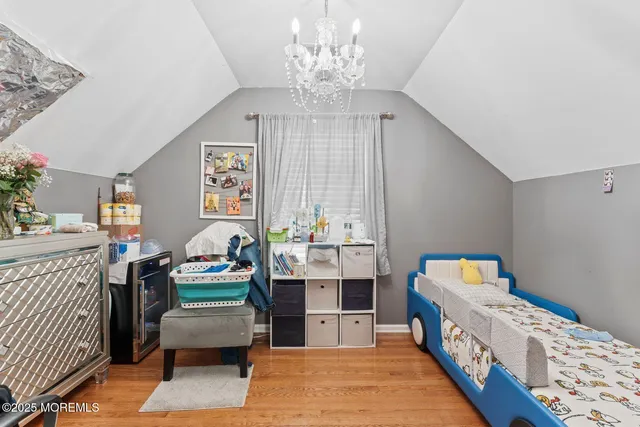 a room with furniture a chandelier and a window