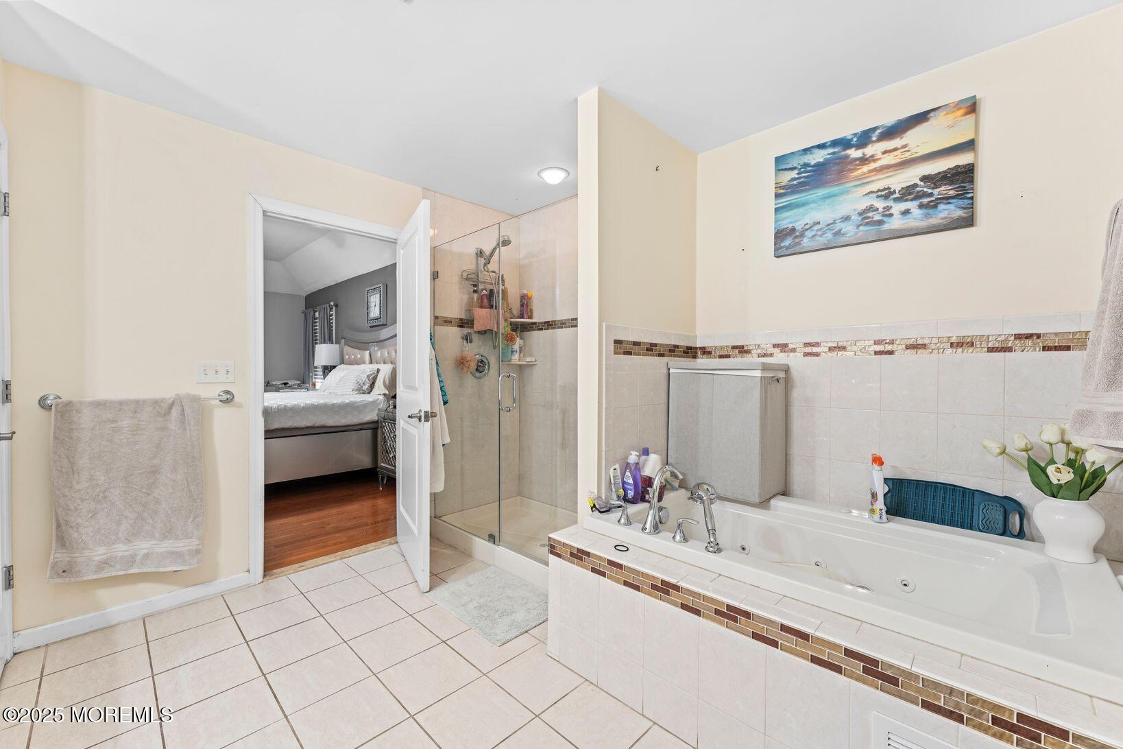 24 Friendship Road Howell, NJ 07731 - Photo 20 of 34 a bathroom with a tub sink and mirror