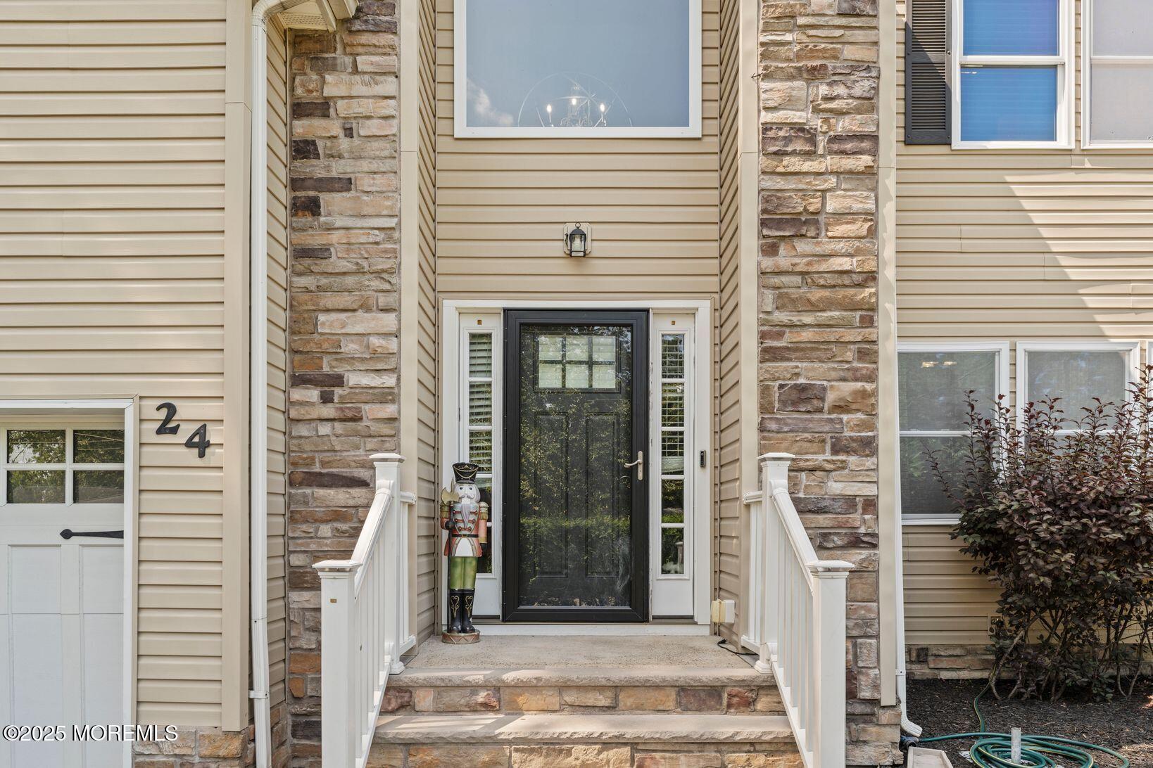24 Friendship Road Howell, NJ 07731 - Photo 2 of 34 a front view of a house with a garden
