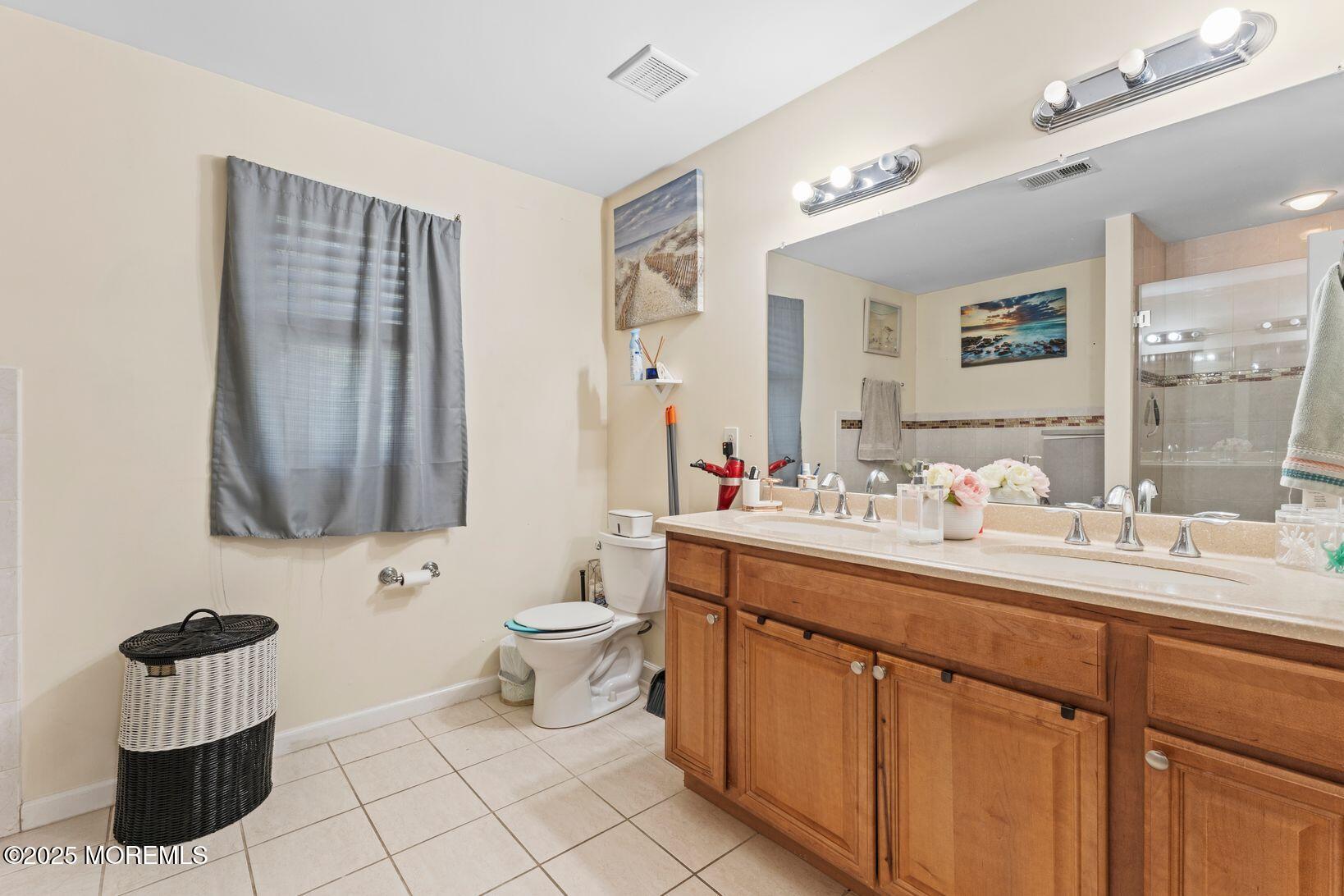 24 Friendship Road Howell, NJ 07731 - Photo 21 of 34 a bathroom with a toilet sink and mirror