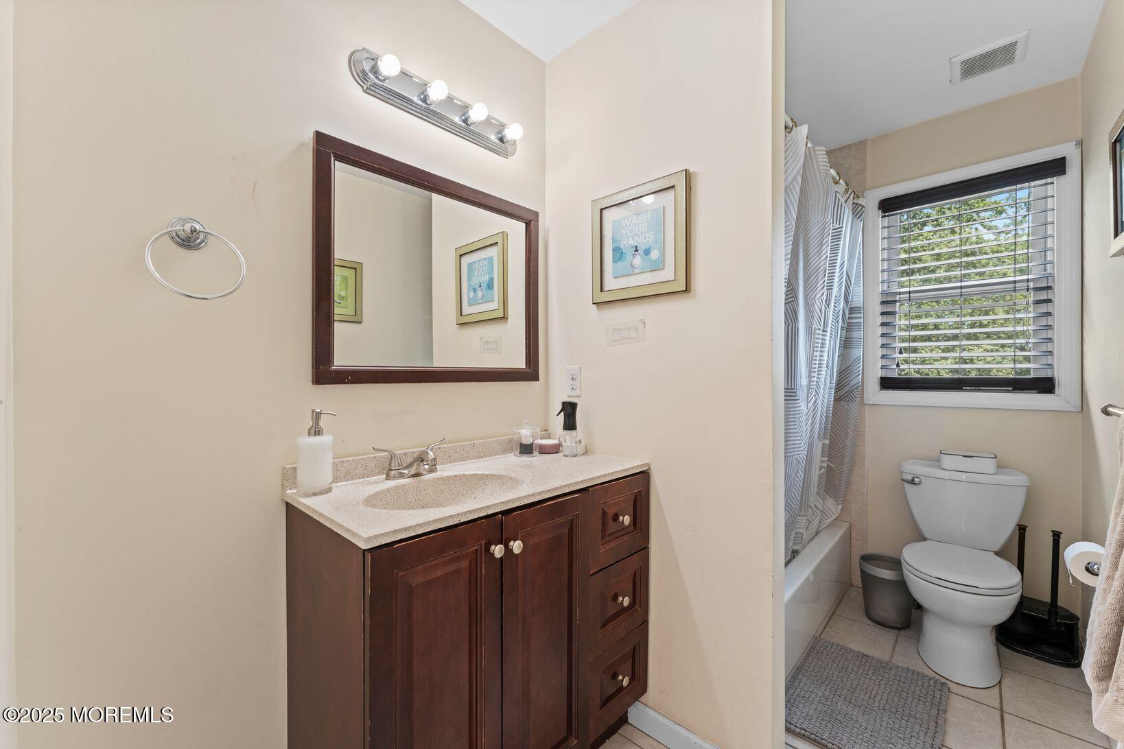 24 Friendship Road Howell, NJ 07731 - Photo 22 of 34 a bathroom with a toilet sink and mirror