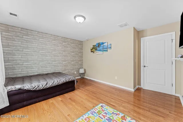 a view of bedroom with furniture and wooden floor