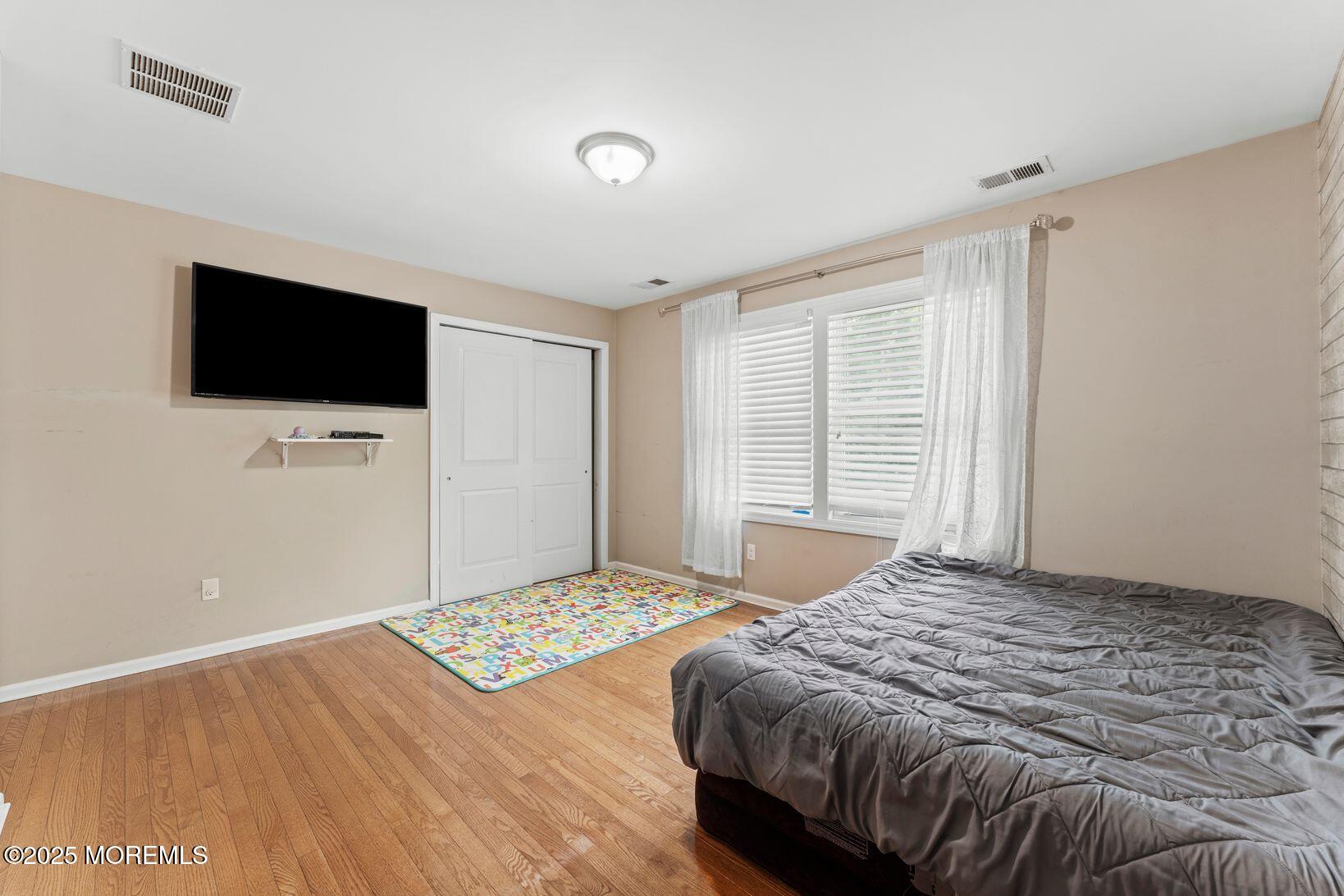 24 Friendship Road Howell, NJ 07731 - Photo 24 of 34 a bedroom with a bed and a flat screen tv