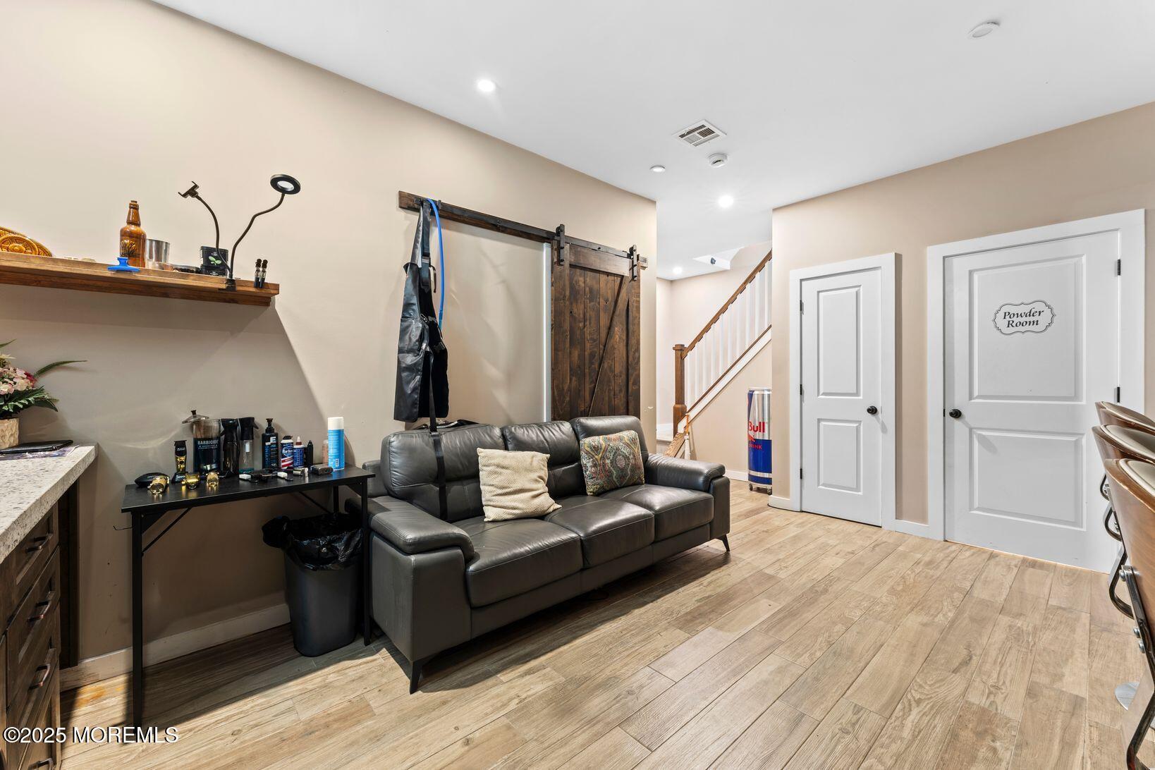 24 Friendship Road Howell, NJ 07731 - Photo 26 of 34 a living room with furniture and a wooden floor