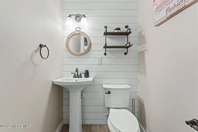 a bathroom with a toilet a sink and a mirror